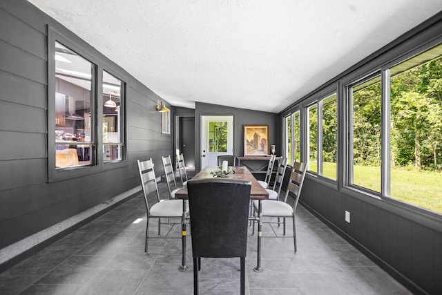 sunroom / solarium featuring lofted ceiling