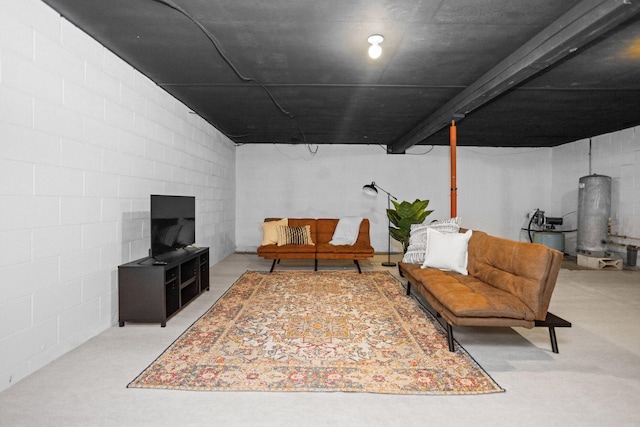 living area featuring water heater and concrete floors