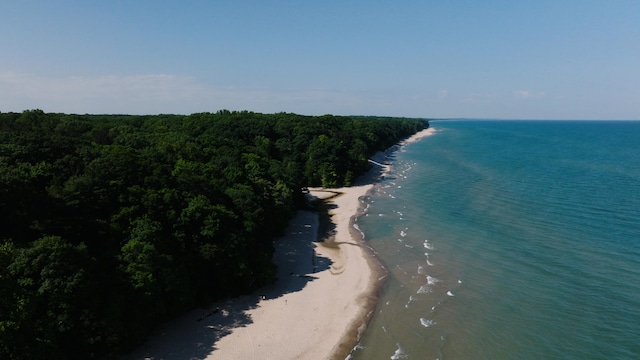 drone / aerial view featuring a water view and a beach view