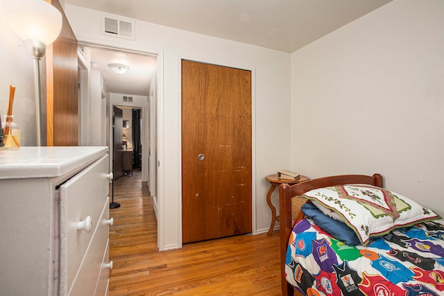 bedroom featuring light wood-type flooring and a closet