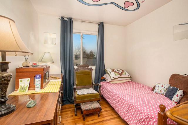 bedroom with hardwood / wood-style floors