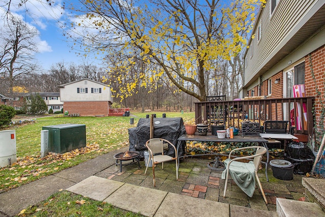 view of patio featuring an outdoor fire pit and a wooden deck