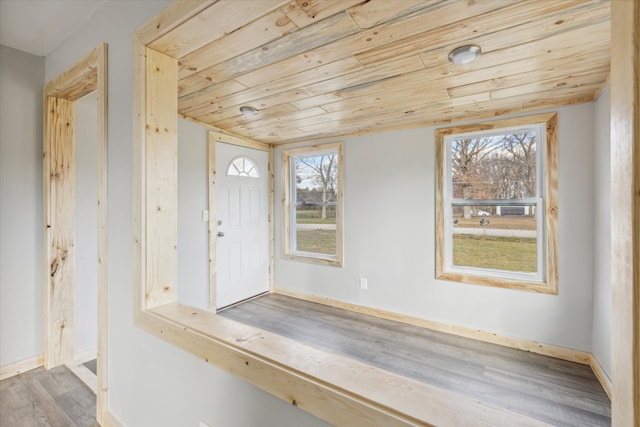 entrance foyer featuring light hardwood / wood-style flooring, wood ceiling, and plenty of natural light