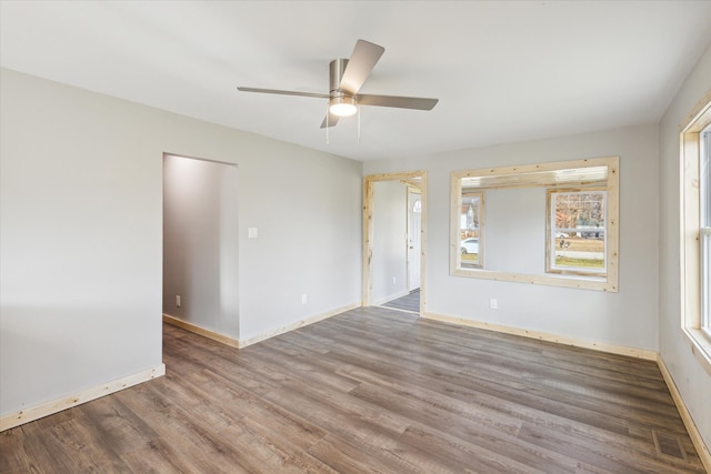 empty room featuring wood-type flooring and ceiling fan