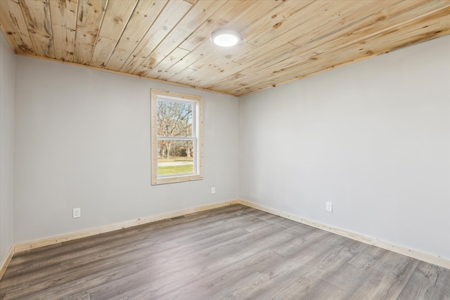 unfurnished room featuring wood ceiling and light hardwood / wood-style flooring