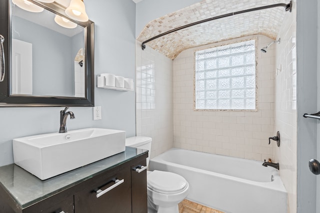 full bathroom featuring vanity, toilet, and tiled shower / bath