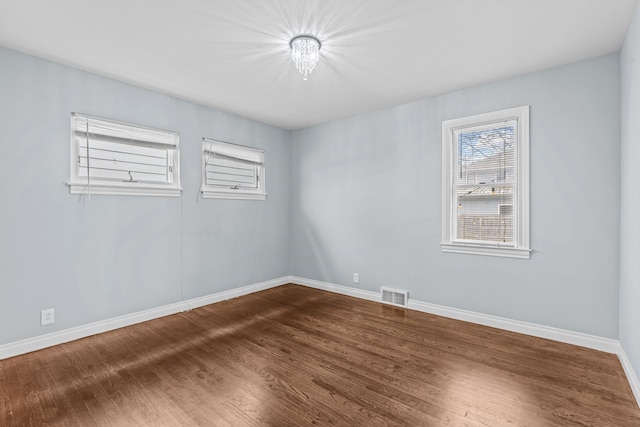 unfurnished room with hardwood / wood-style flooring