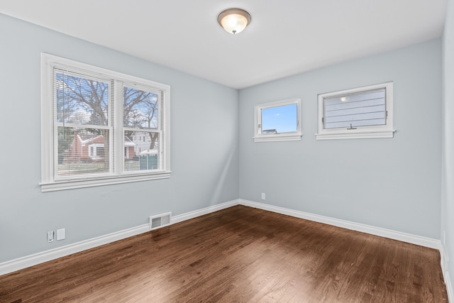 empty room with dark hardwood / wood-style floors