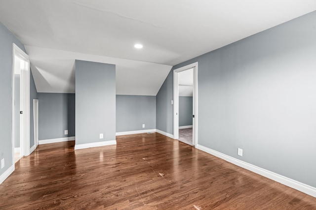 interior space with dark wood-type flooring and lofted ceiling