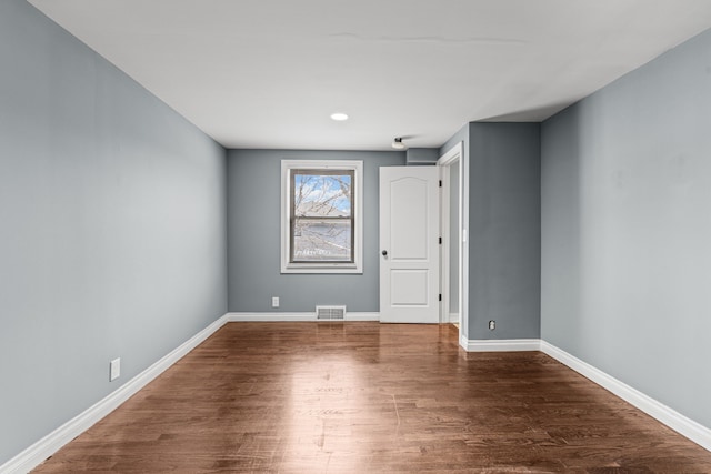 empty room with dark wood-type flooring