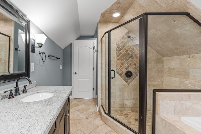 bathroom with shower with separate bathtub, vanity, and vaulted ceiling