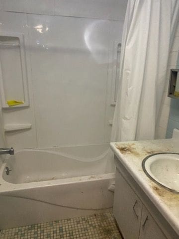 bathroom featuring tile patterned floors, vanity, and shower / bathtub combination with curtain