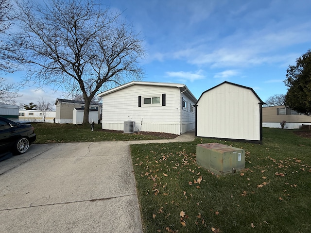 5052 Kenway Ct S, Sterling Heights, MI 48310 - view of home's exterior with a lawn and central AC