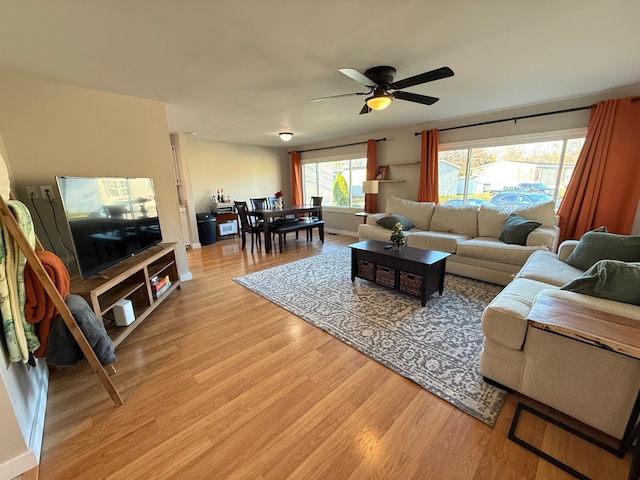 living room featuring light hardwood / wood-style flooring and ceiling fan