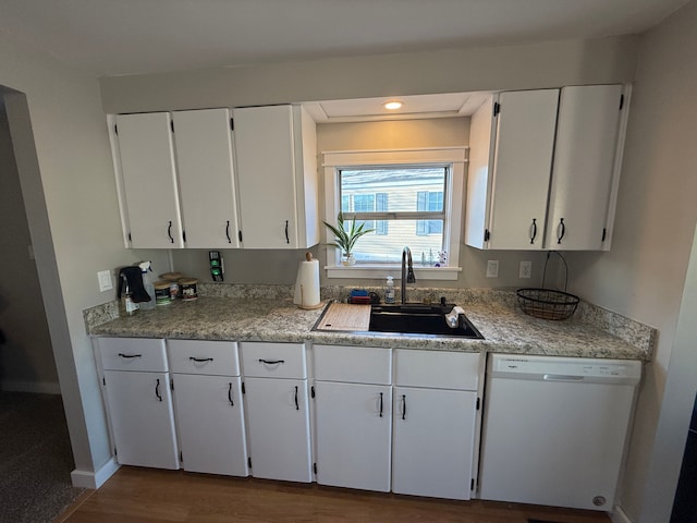 kitchen with white cabinetry, dishwasher, wood-type flooring, and sink