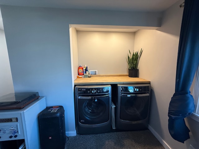 washroom featuring washing machine and dryer and dark carpet