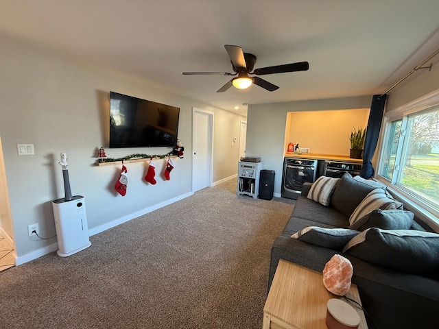 living room with ceiling fan, carpet floors, and washer / dryer