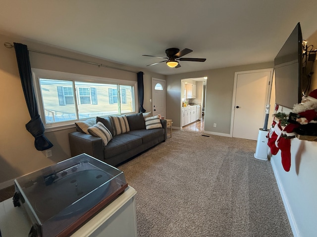 living room featuring carpet floors and ceiling fan