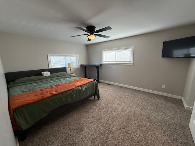 carpeted bedroom featuring multiple windows and ceiling fan