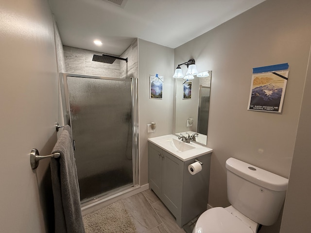 bathroom with vanity, toilet, and walk in shower