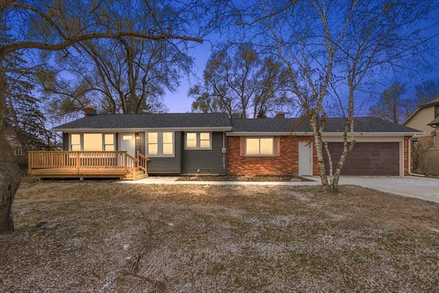 ranch-style home with a wooden deck and a garage