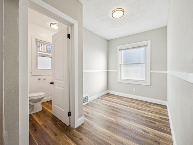 16162 Normandy St, Detroit, MI 48221 - bathroom featuring toilet, wood finished floors, healthy amount of natural light, and baseboards
