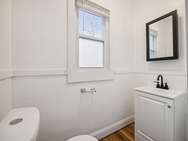 16162 Normandy St, Detroit, MI 48221 - bathroom with toilet, vanity, wood finished floors, and a baseboard heating unit