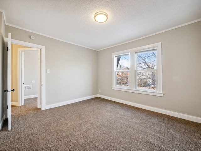 carpeted empty room featuring crown molding and a textured ceiling