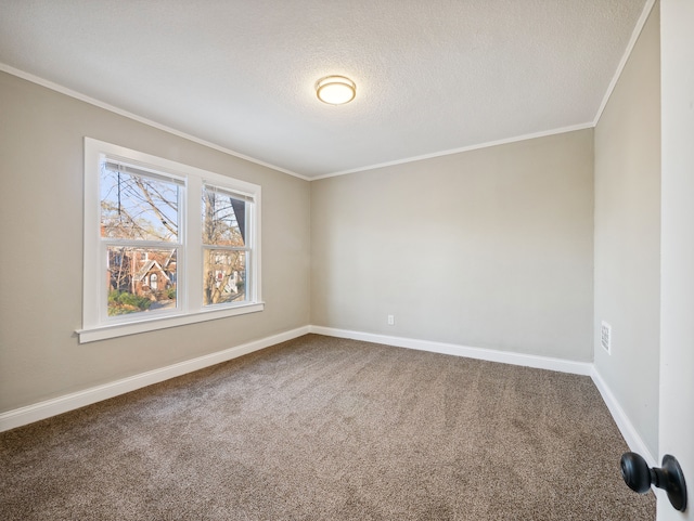 carpeted empty room with ornamental molding and a textured ceiling