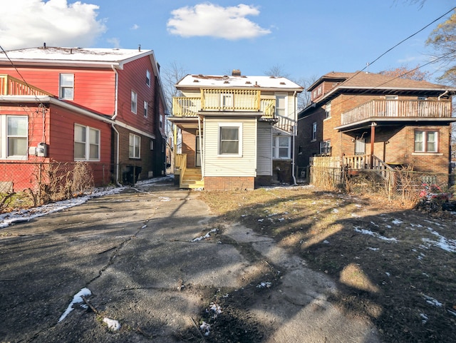 back of property featuring a balcony