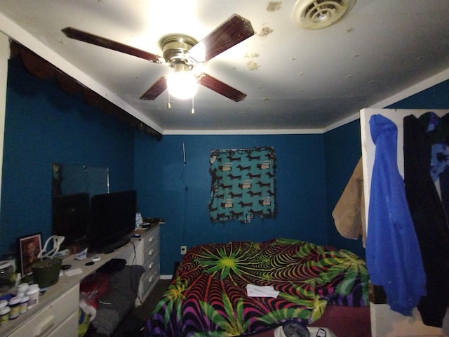 bedroom with ceiling fan and crown molding