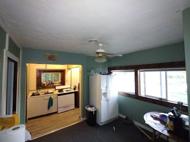 kitchen with ceiling fan, white appliances, and hardwood / wood-style flooring