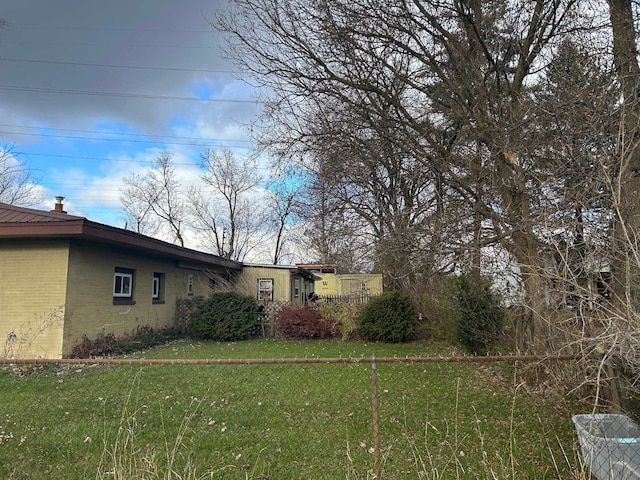 view of home's exterior featuring a yard