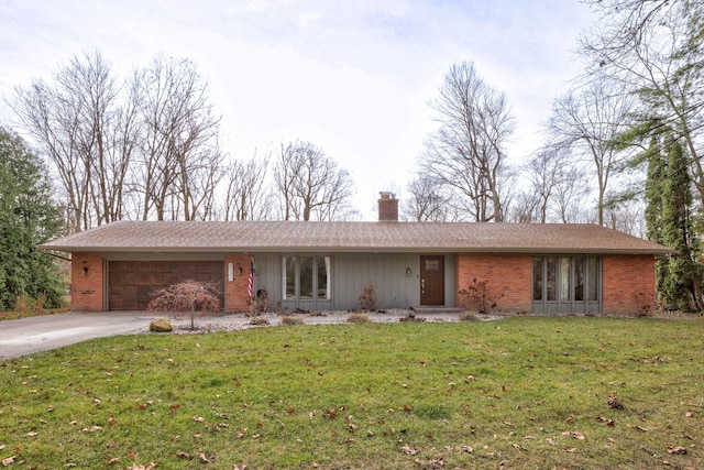 ranch-style house with a garage and a front lawn