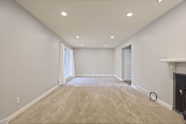 unfurnished living room featuring light colored carpet