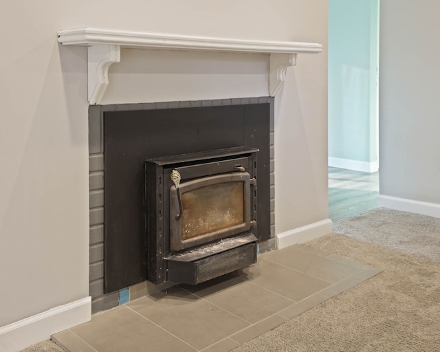 room details featuring carpet floors and a wood stove