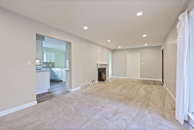 unfurnished living room with light carpet