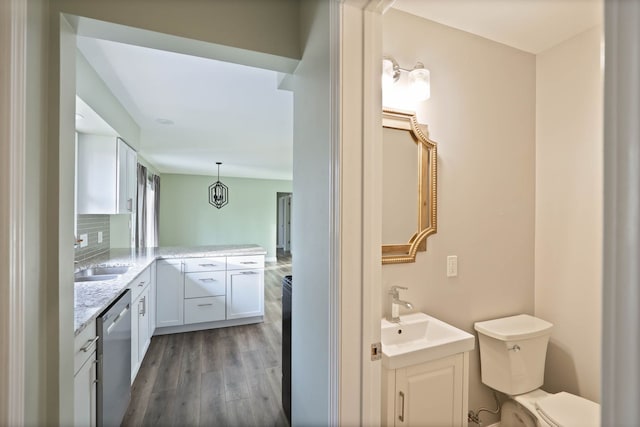 bathroom featuring hardwood / wood-style floors, vanity, and toilet