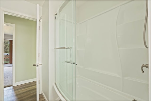 bathroom featuring hardwood / wood-style flooring and a shower with door