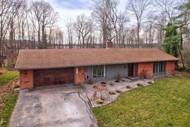 single story home featuring a garage and a front lawn