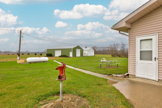 view of community with a yard and an outdoor structure