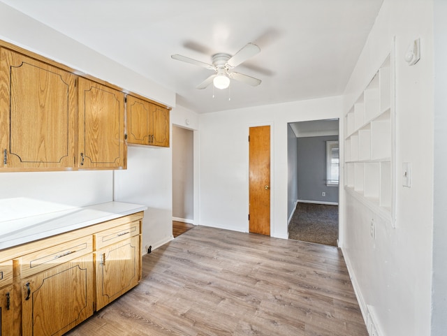 20019 Westbrook St, Detroit, MI 48219 - kitchen featuring a ceiling fan, light countertops, baseboards, light wood-type flooring, and brown cabinetry
