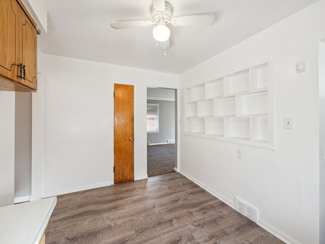 empty room featuring ceiling fan and hardwood / wood-style flooring