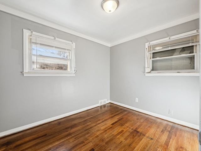 spare room with wood-type flooring