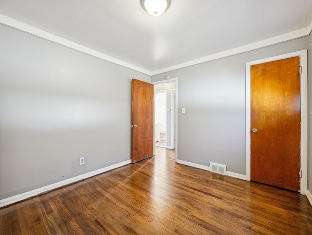 unfurnished bedroom with hardwood / wood-style flooring