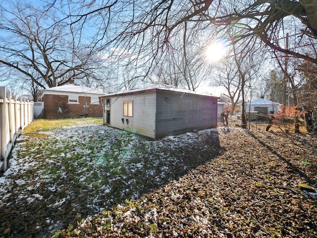 rear view of property featuring an outdoor structure