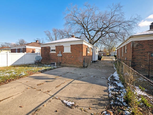 20019 Westbrook St, Detroit, MI 48219 - view of property exterior with brick siding, concrete driveway, and a chimney