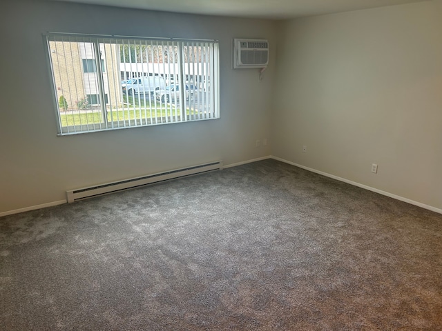 empty room with dark colored carpet, a baseboard radiator, and a wall unit AC