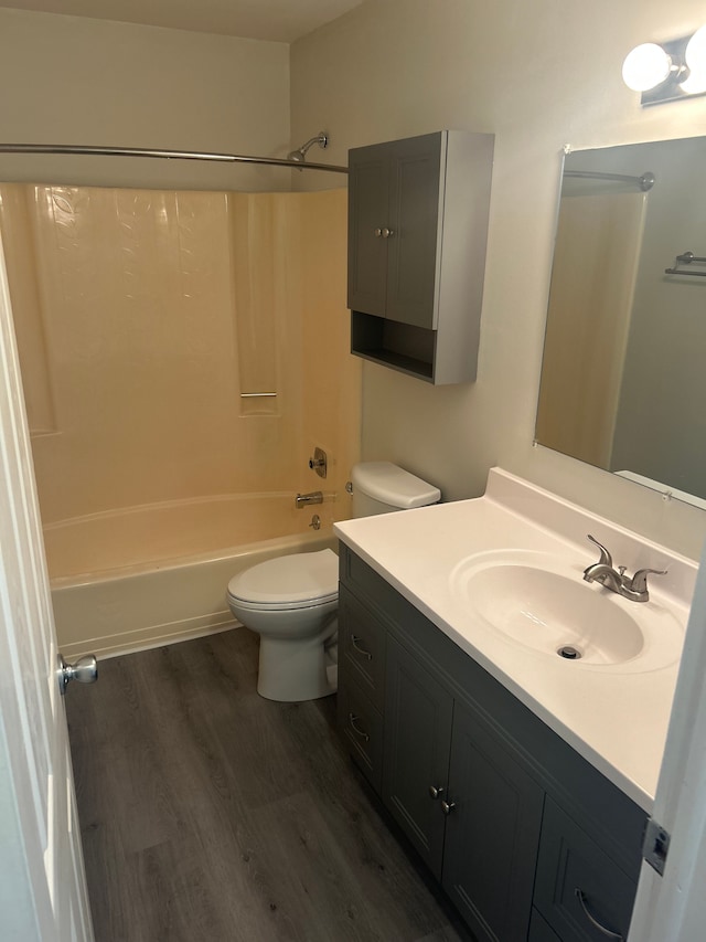 full bathroom featuring vanity, toilet, washtub / shower combination, and hardwood / wood-style flooring