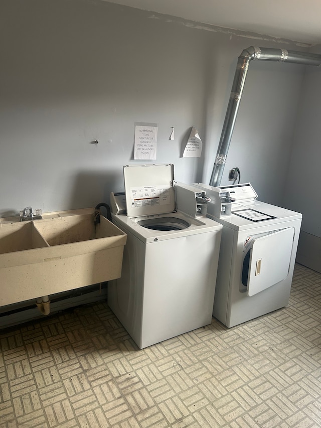 laundry area with washer and dryer and sink